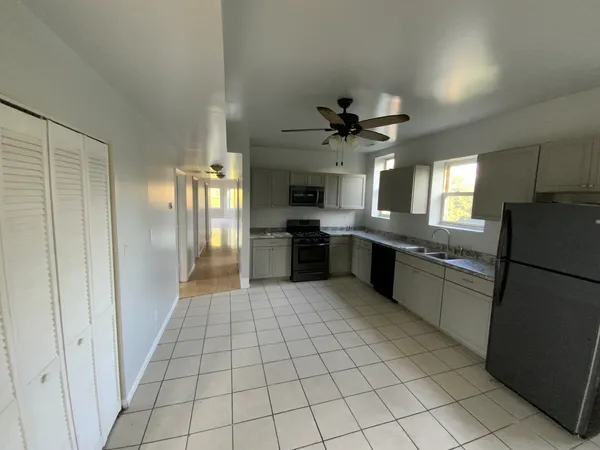 a large kitchen with cabinets and stainless steel appliances