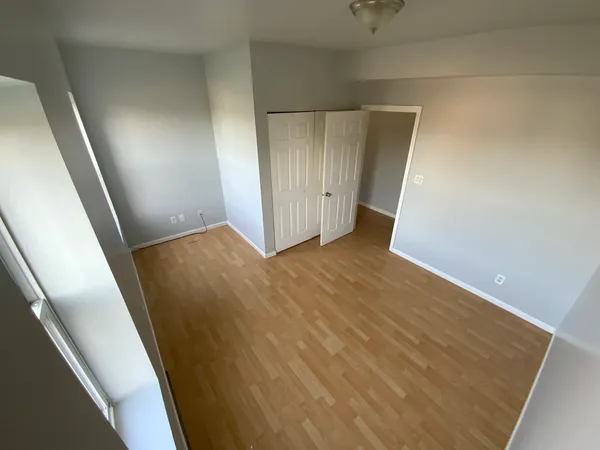 a view of hallway with wooden floor