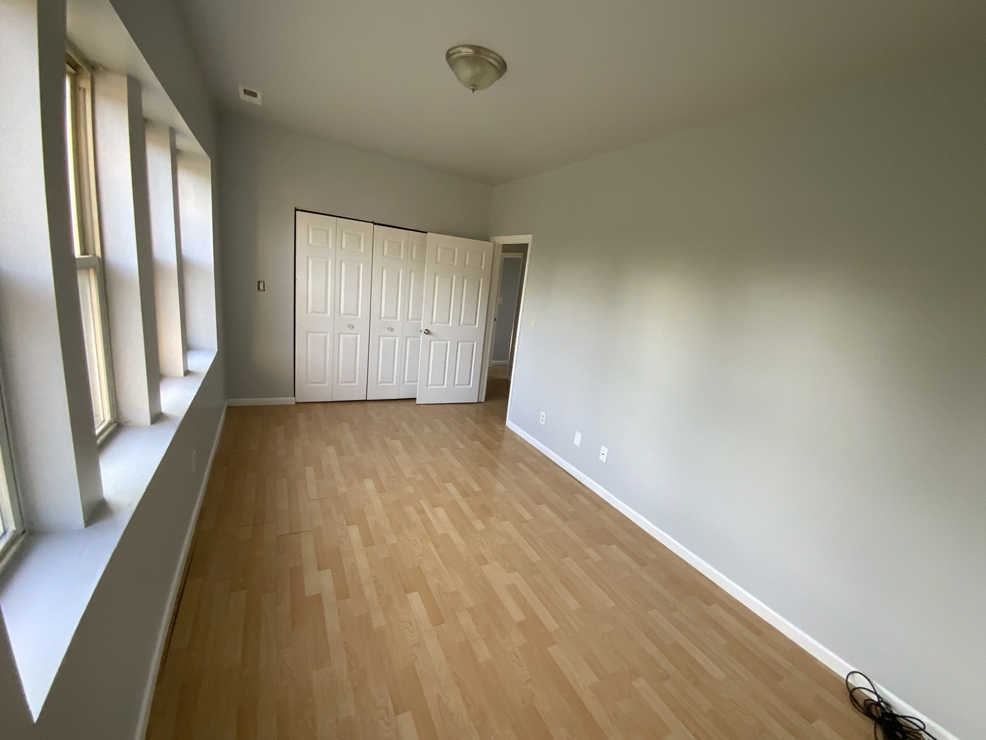 6508 South Morgan Street, Unit 3 Chicago, IL 60621 - Photo 8 of 11 a view of a room with wooden floor and windows
