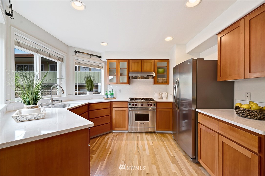 420 Northeast Maple Leaf Place, Unit B Seattle, WA 98115 - Photo 2 of 24 a kitchen with stainless steel appliances granite countertop a sink stove and refrigerator