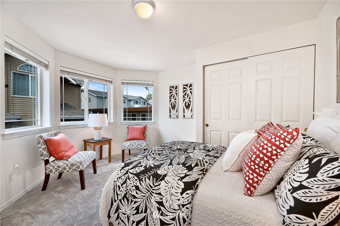 420 Northeast Maple Leaf Place, Unit B Seattle, WA 98115 - Photo 11 of 24 a bedroom with a bed and wooden floor