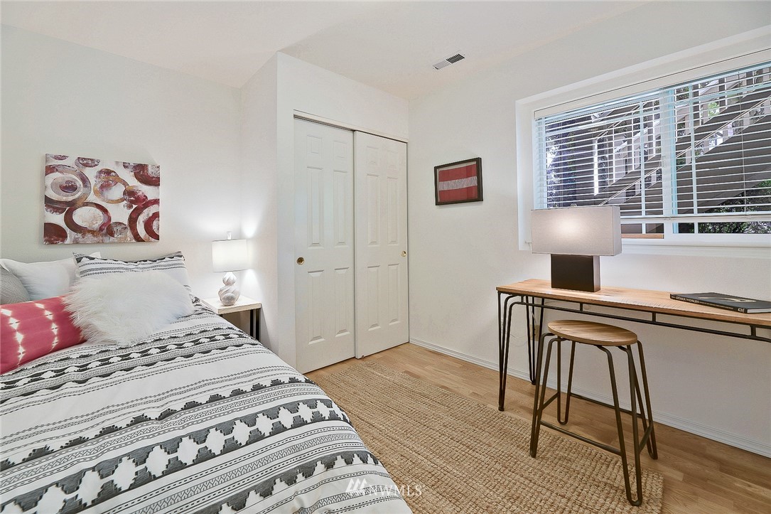 420 Northeast Maple Leaf Place, Unit B Seattle, WA 98115 - Photo 13 of 24 a bedroom with a bed and a table in it