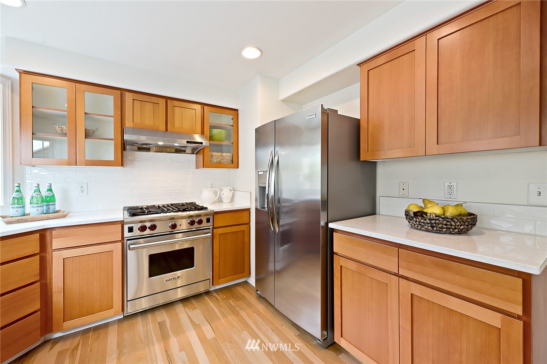 420 Northeast Maple Leaf Place, Unit B Seattle, WA 98115 - Photo 3 of 24 a kitchen with stainless steel appliances granite countertop a stove a refrigerator and a sink