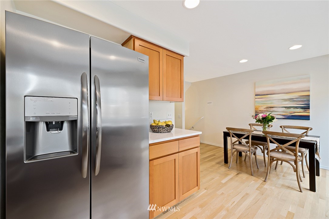 420 Northeast Maple Leaf Place, Unit B Seattle, WA 98115 - Photo 5 of 24 a kitchen with refrigerator cabinets and wooden floor