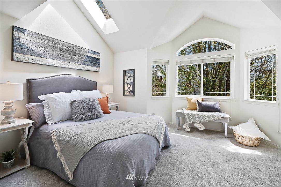 420 Northeast Maple Leaf Place, Unit B Seattle, WA 98115 - Photo 8 of 24 a spacious bedroom with a bed and a large window
