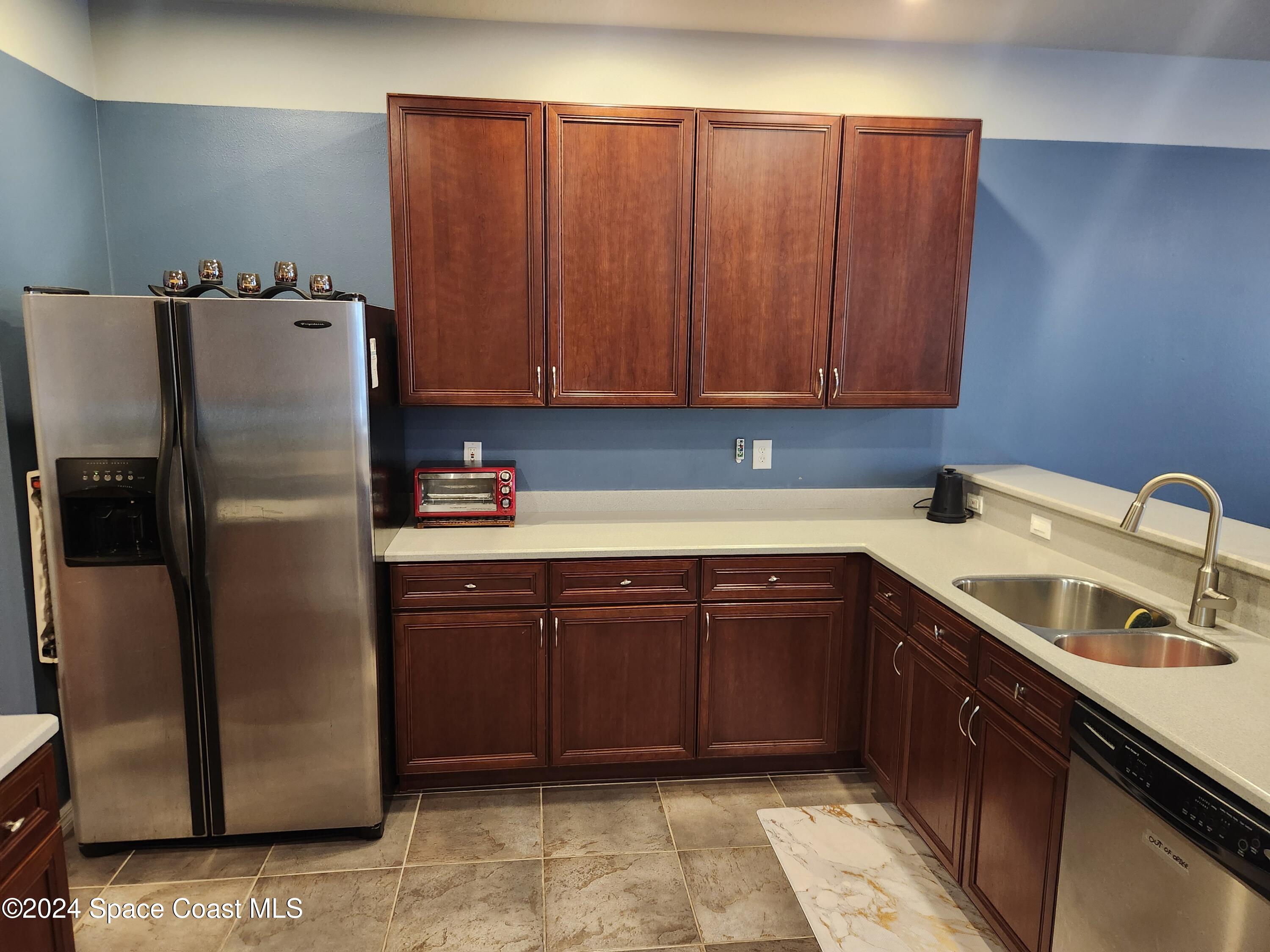 373 Intrepid Way Indialantic, FL 32903 - Photo 11 of 59 a kitchen with stainless steel appliances granite countertop a refrigerator and a sink