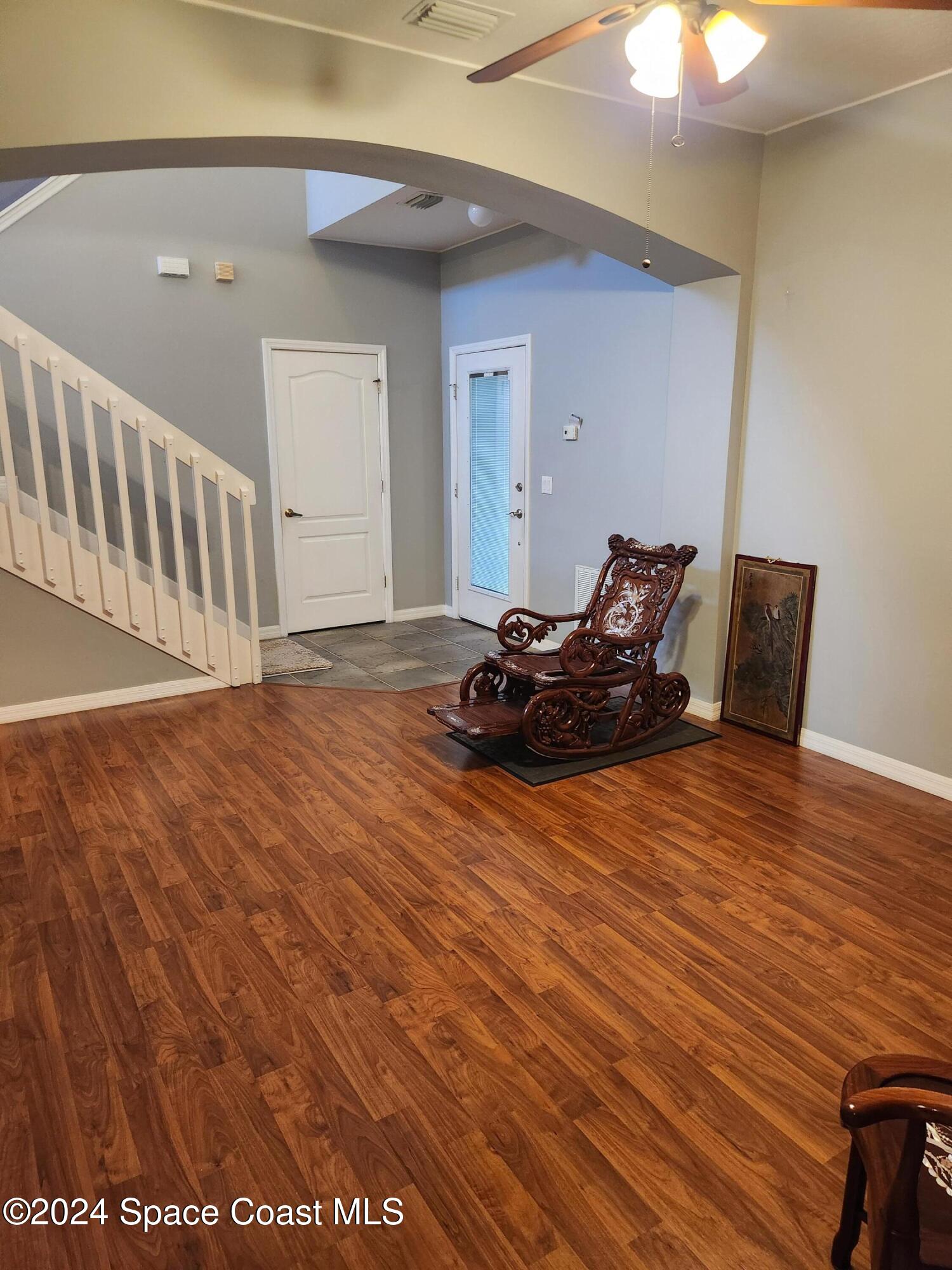 373 Intrepid Way Indialantic, FL 32903 - Photo 15 of 59 a room with wooden floor and furniture