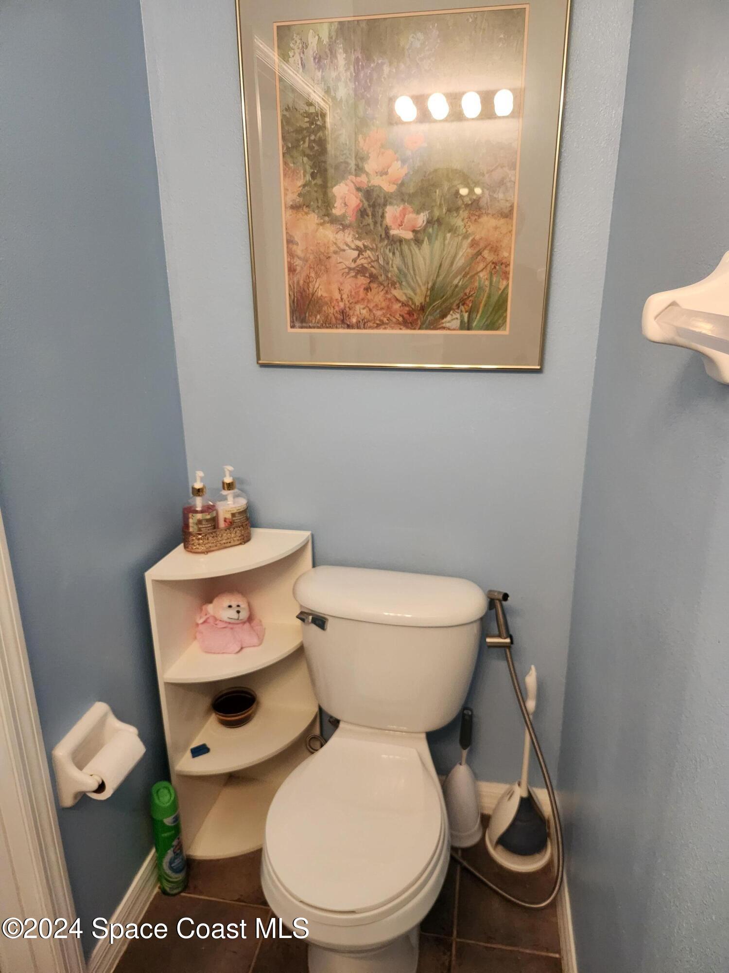 373 Intrepid Way Indialantic, FL 32903 - Photo 18 of 59 a white toilet sitting next to a bathroom sink