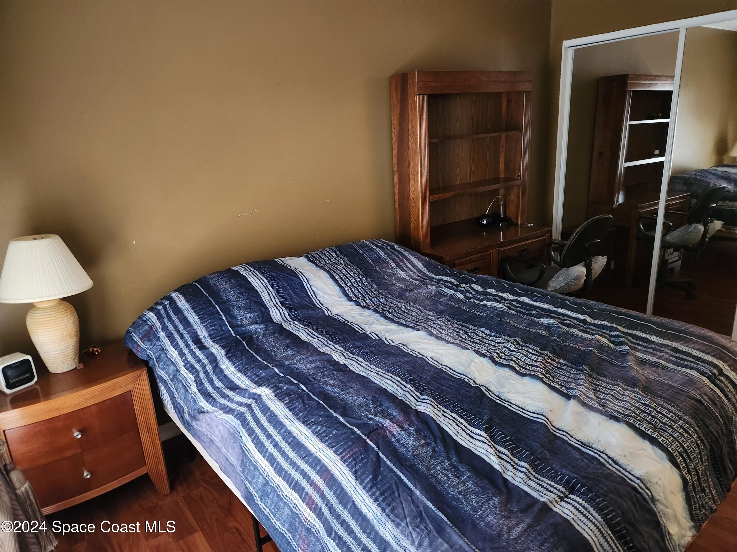 373 Intrepid Way Indialantic, FL 32903 - Photo 29 of 59 a bedroom with a bed and a lamp on dresser