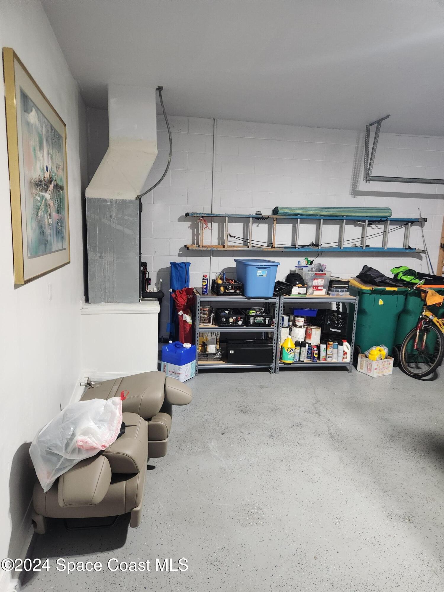 373 Intrepid Way Indialantic, FL 32903 - Photo 53 of 59 a view of a garage with furniture and cars