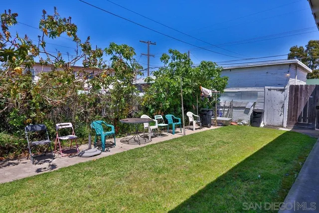 a view of a backyard with sitting area