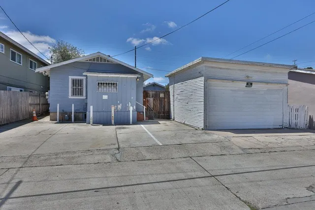 a view of a house with a yard and garage