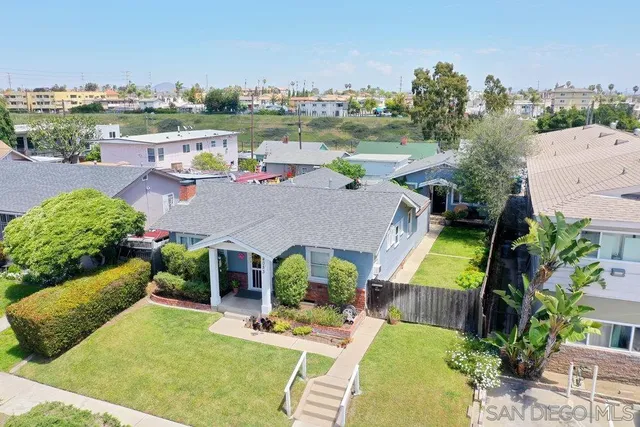 an aerial view of a house with outdoor space patio and lake view