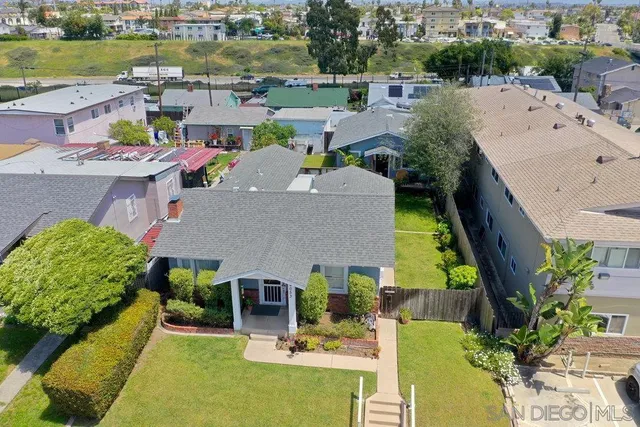 an aerial view of a house with a yard pool patio and outdoor seating