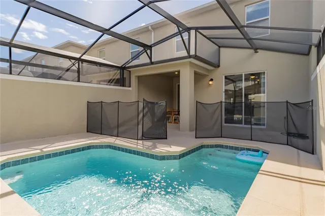 a bedroom with a bed and a chandelier fan