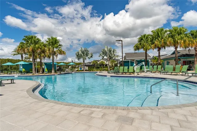 a view of a house with swimming pool and sitting area