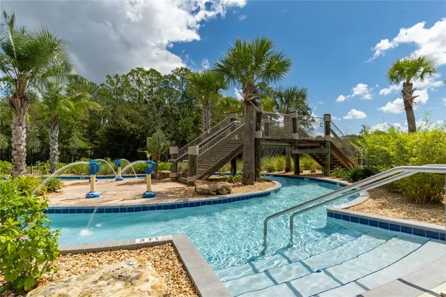 a swimming pool with barbeque oven outdoor seating and yard