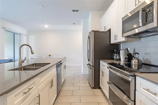a living room with a dining table and chairs