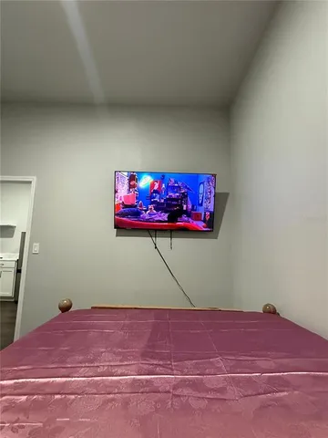 a room with a bed and a wall painting