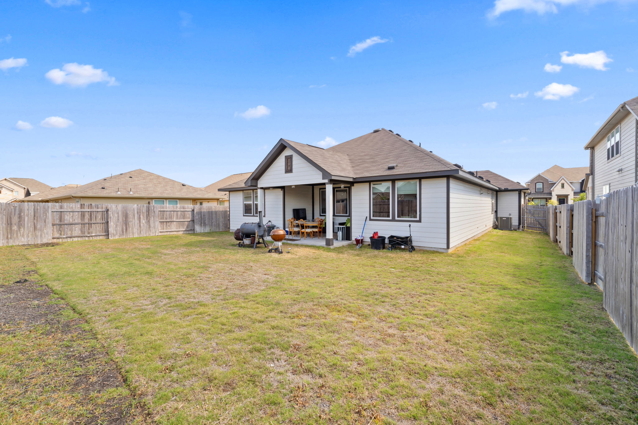 4009 Milano River Road Hutto, TX 78634 - Photo 33 of 39 Rear view of property with a patio area and a fenced backyard