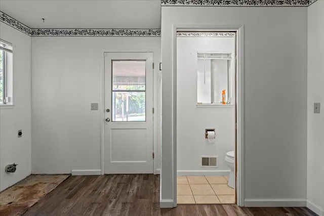 a view of a livingroom with wooden floor and a window