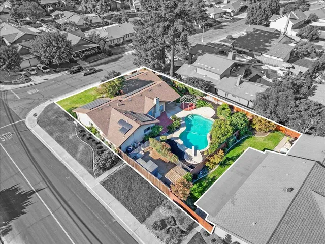 an aerial view of residential houses with outdoor space and street view