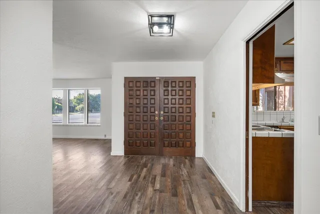 wooden floor in an empty room with a window