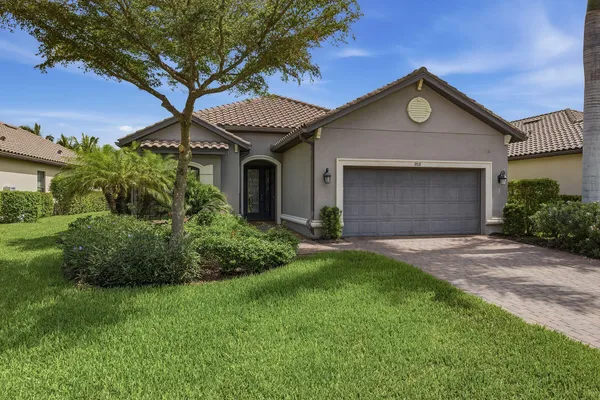 a front view of a house with a yard and garage