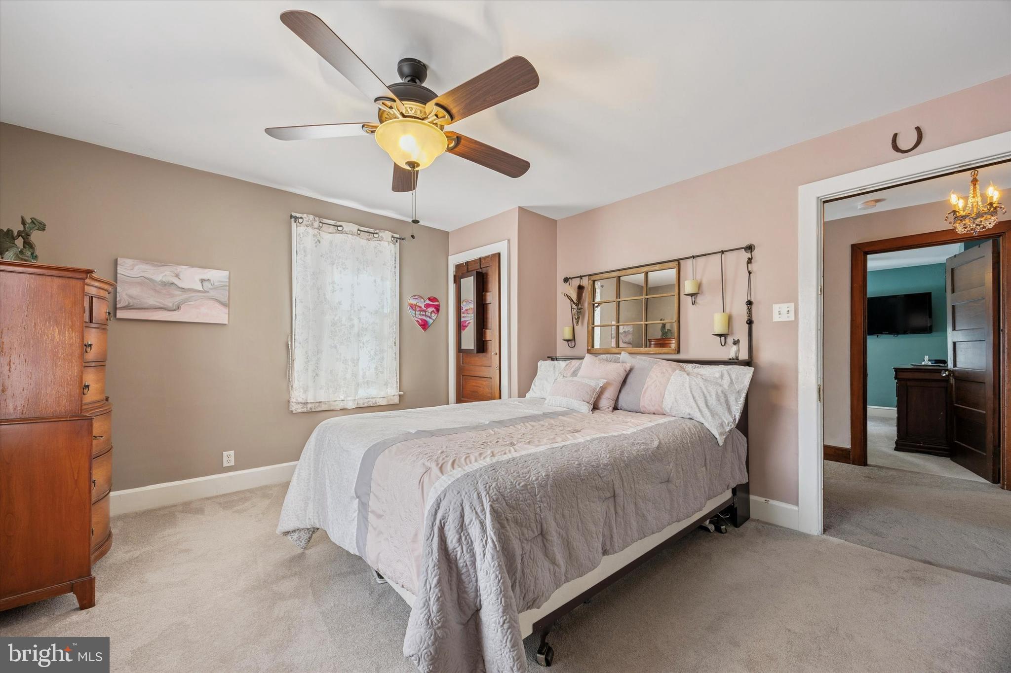 16 Chelten Road Havertown, PA 19083 - Photo 15 of 24 a bedroom with a large bed and a chandelier