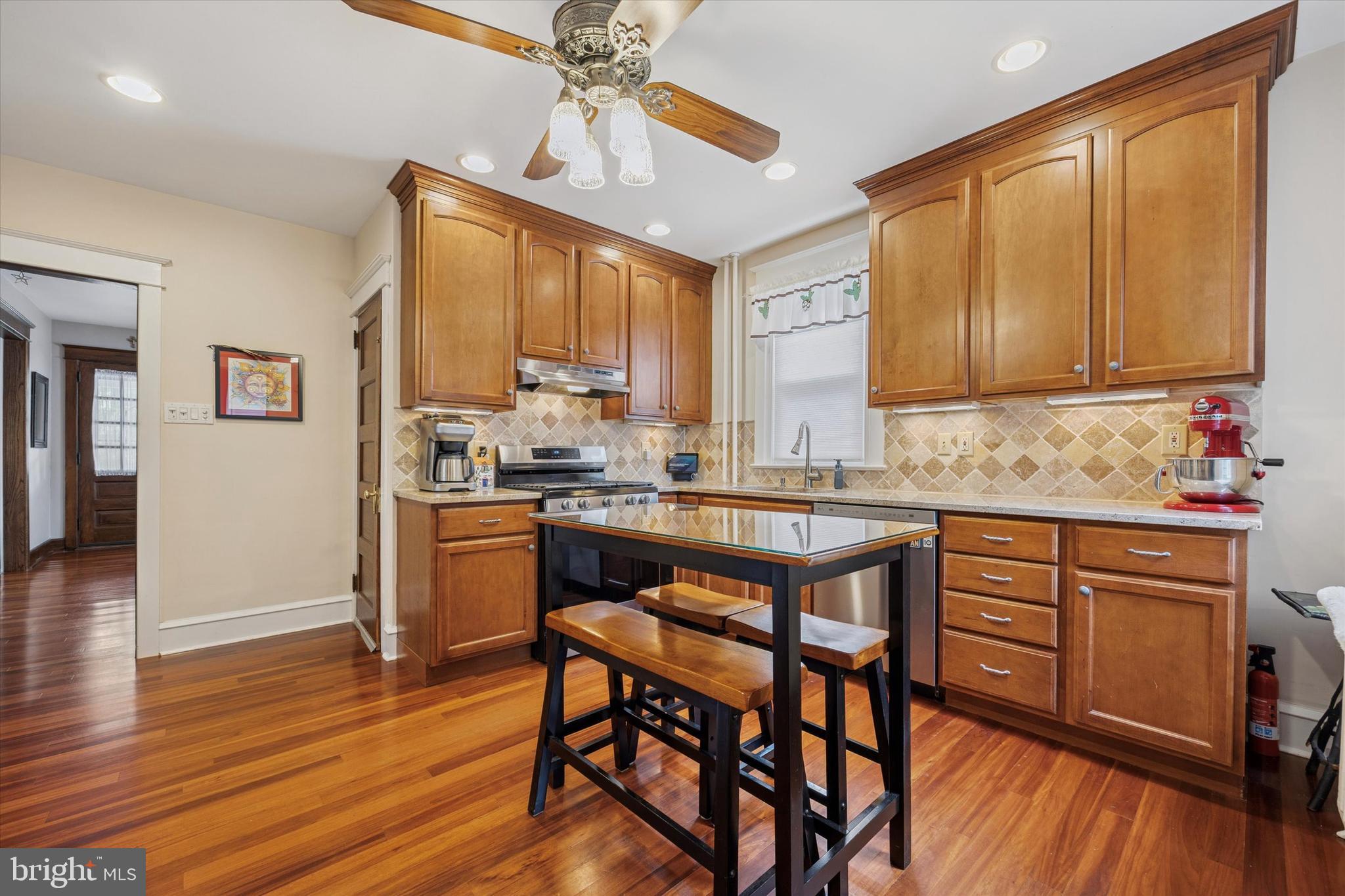 16 Chelten Road Havertown, PA 19083 - Photo 6 of 24 a kitchen with stainless steel appliances granite countertop wooden floors stove and cabinets