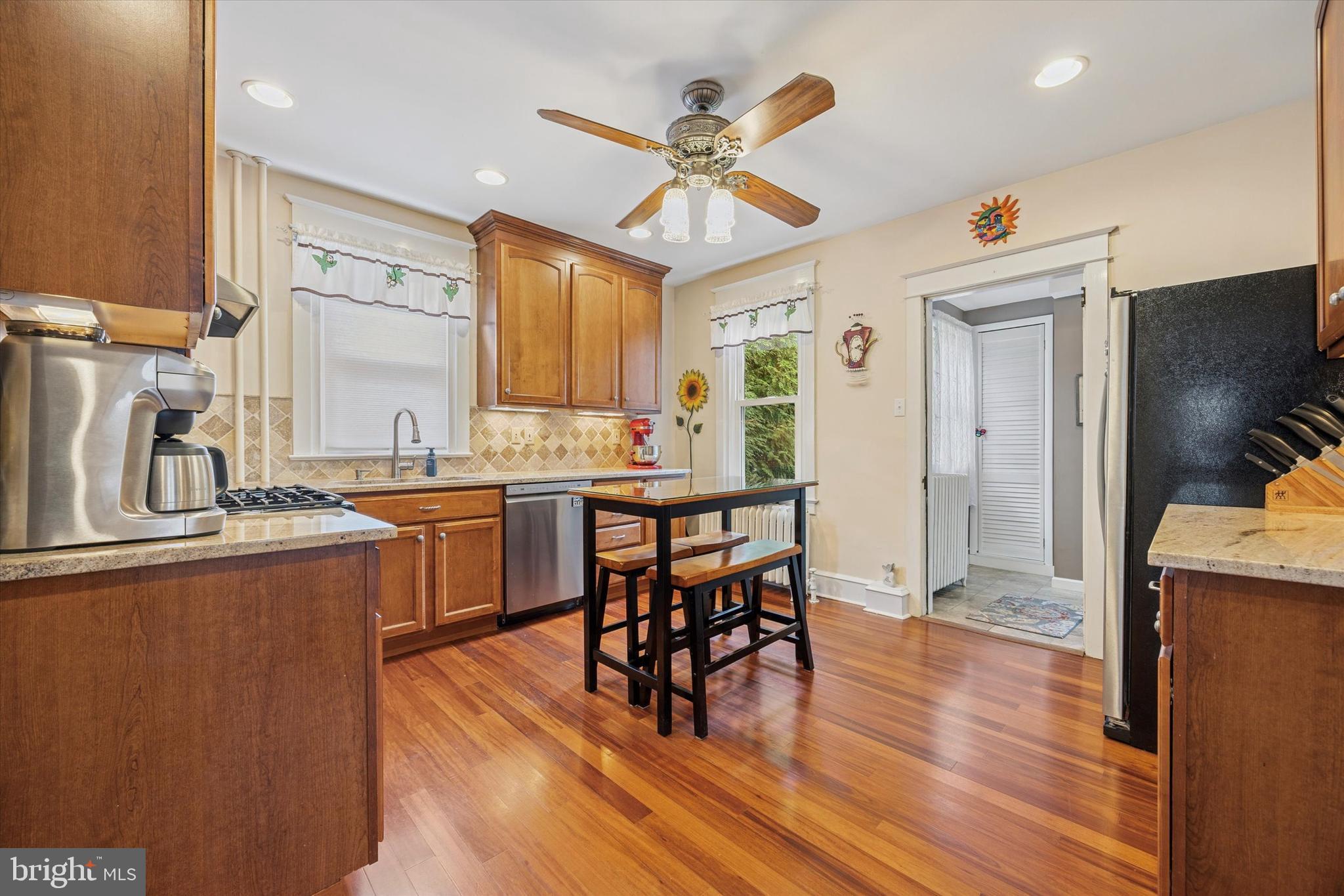 16 Chelten Road Havertown, PA 19083 - Photo 7 of 24 a open kitchen with stainless steel appliances granite countertop a sink dishwasher a stove and a refrigerator with wooden floor
