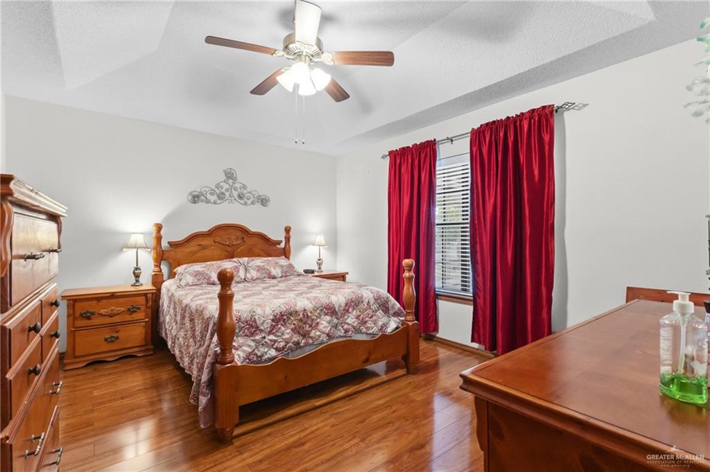 1909 Tyler Street Mission, TX 78572 - Photo 13 of 17 a bedroom with a bed and a chandelier