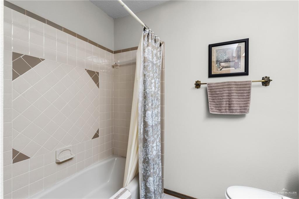 1909 Tyler Street Mission, TX 78572 - Photo 15 of 17 a bathroom with a shower and a toilet