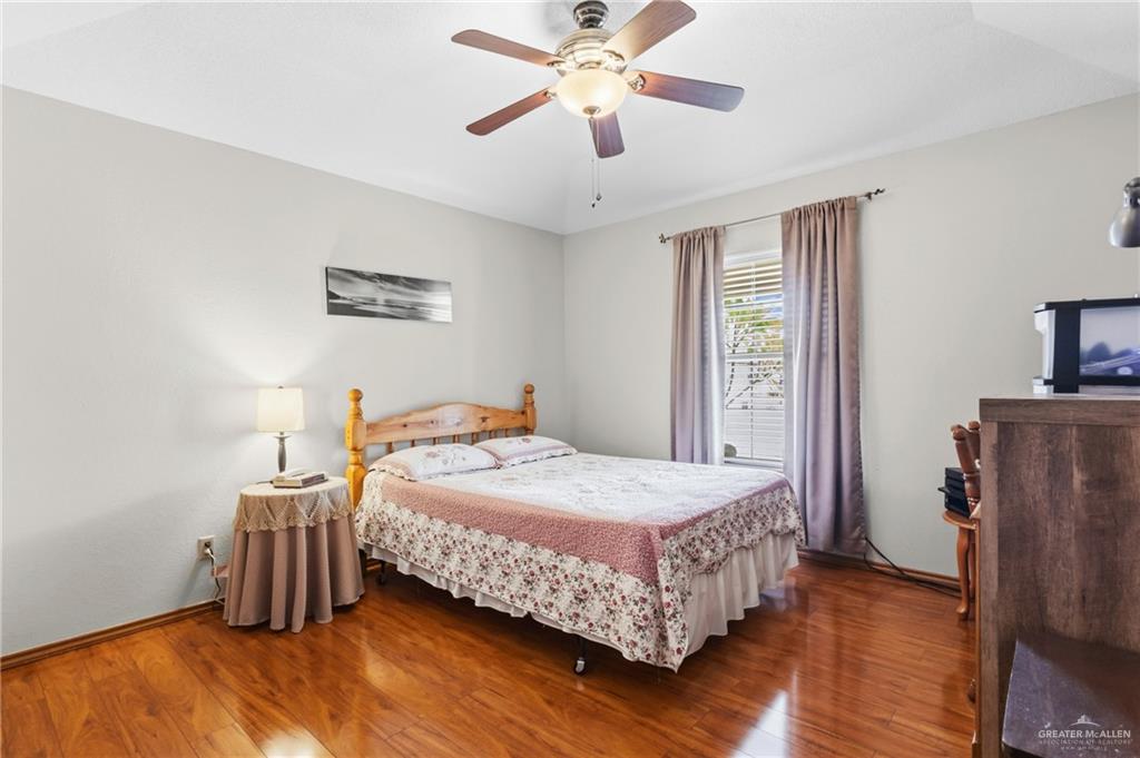 1909 Tyler Street Mission, TX 78572 - Photo 16 of 17 a bedroom with a bed and a chandelier