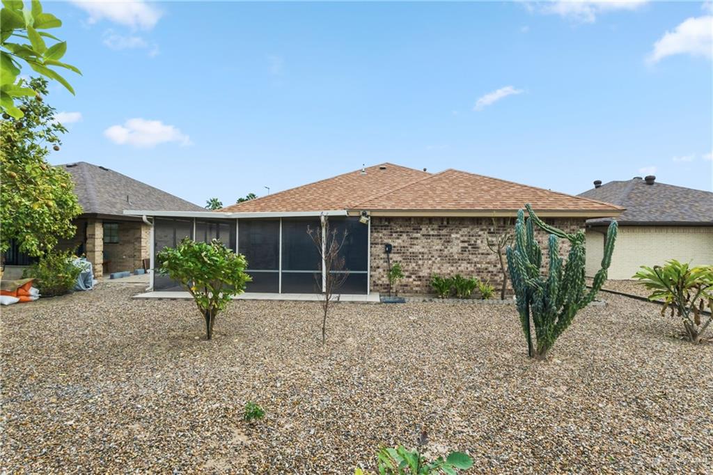 1909 Tyler Street Mission, TX 78572 - Photo 5 of 17 a view of a house with a garden and plants