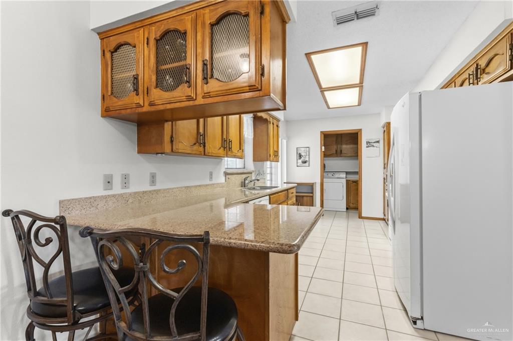 1909 Tyler Street Mission, TX 78572 - Photo 7 of 17 a kitchen with stainless steel appliances granite countertop a stove and a cabinets