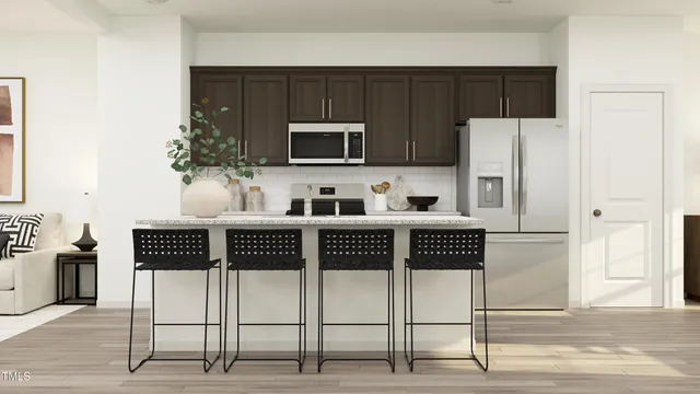 a kitchen with stainless steel appliances a refrigerator a stove a microwave and cabinets