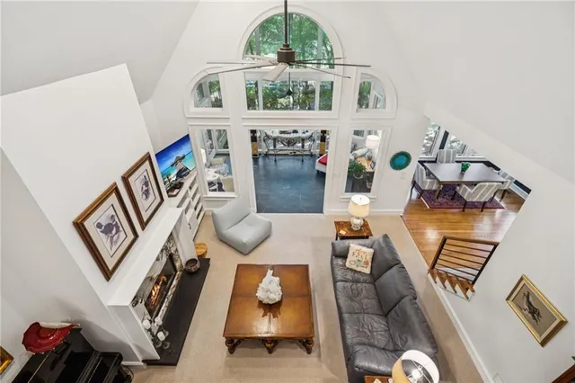 a view of a wooden deck next to a large trees