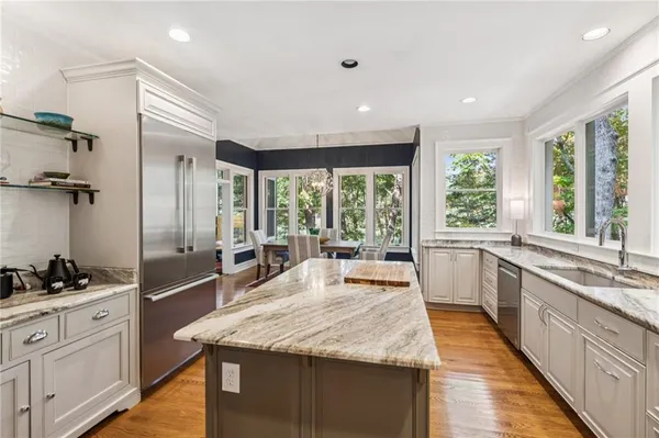 a kitchen that has a sink and a stove top oven