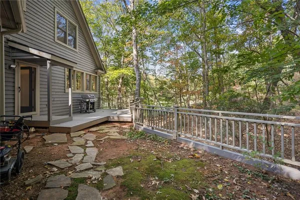 a bedroom with a bed and a flat tv screen on dresser