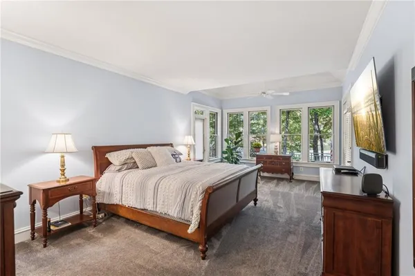 a bathroom with double vanity sinks a large mirror and a shower