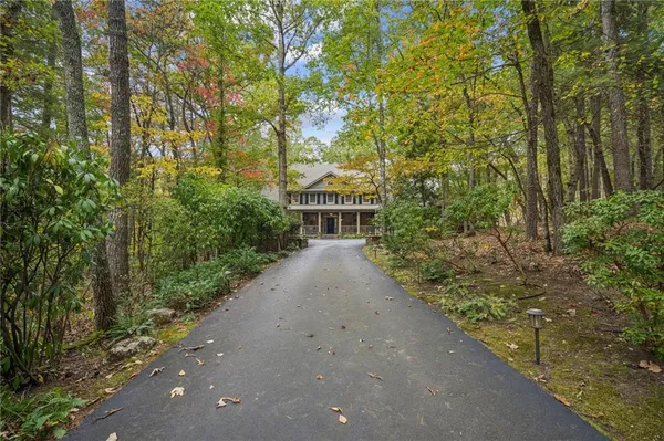 a front view of a house with a yard and fountain