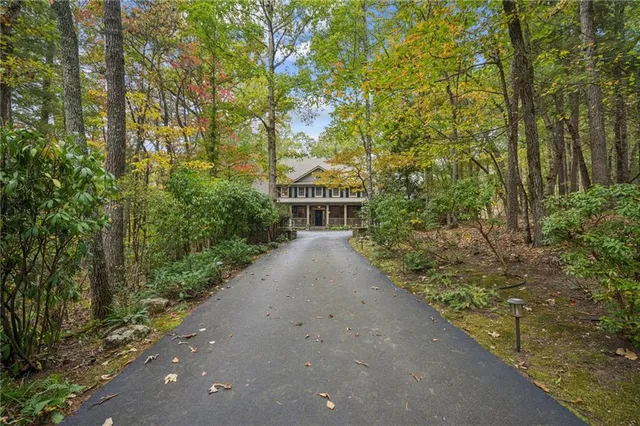 a front view of a house with a yard and fountain