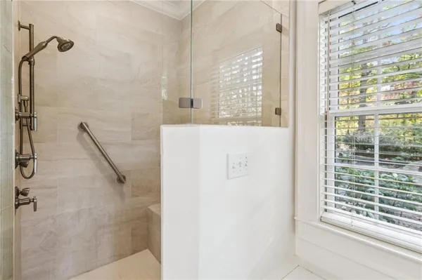 a spacious bathroom with a granite countertop sink and a mirror