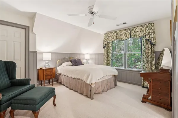 a living room with furniture a rug and a chandelier
