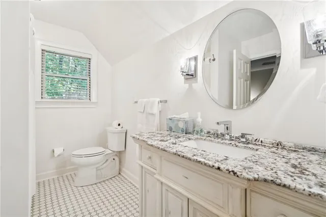 a living room with furniture a fireplace and a chandelier