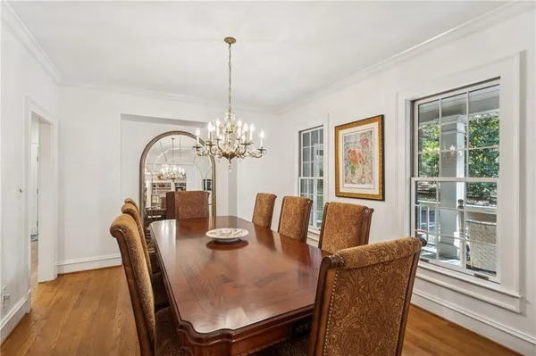 a living room with furniture fireplace and a large window