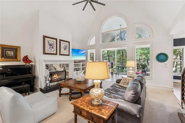 a living room with furniture a table and a large window