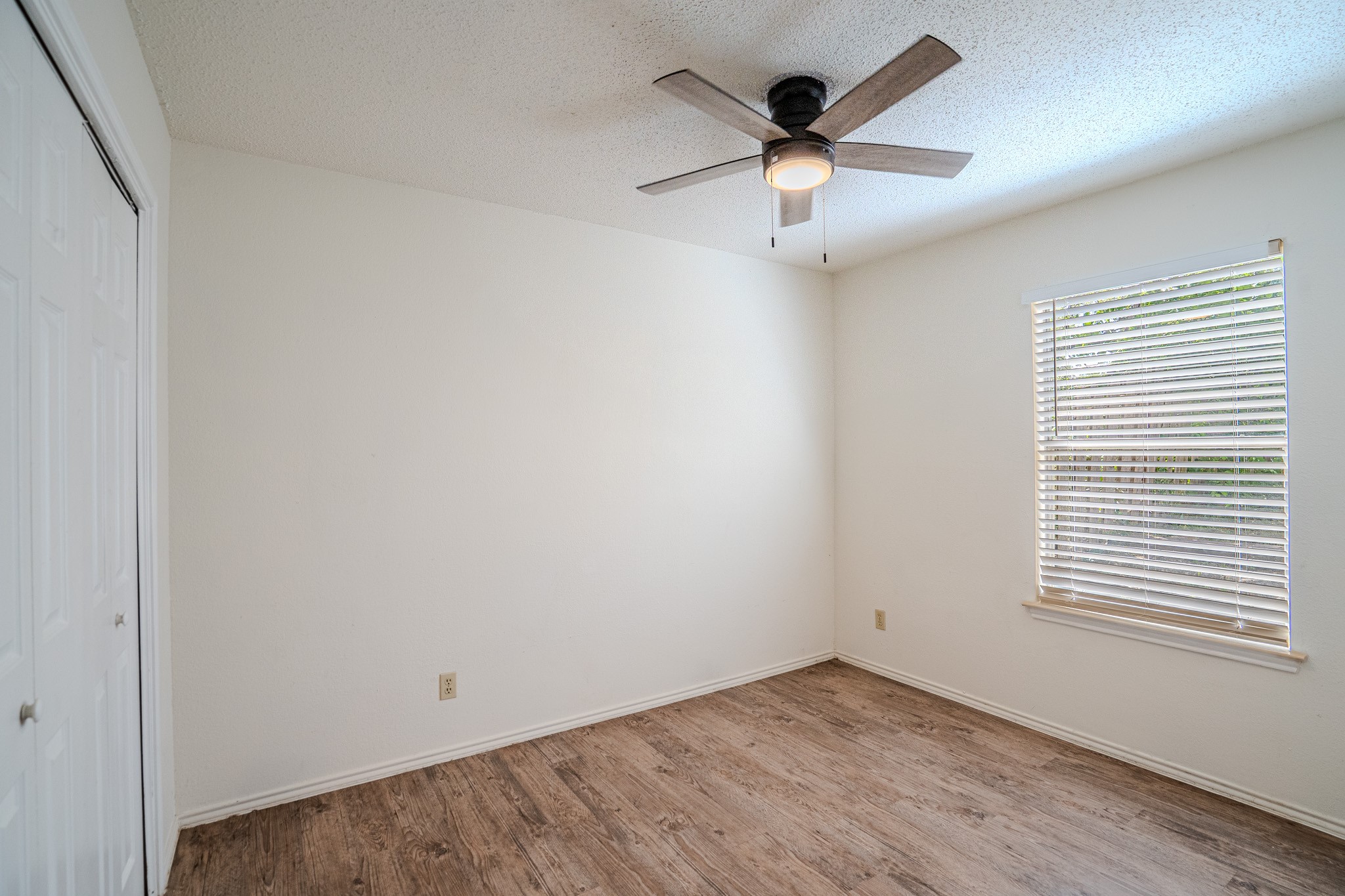 517 Cutty Trail, Unit B Lakeway, TX 78734 - Photo 9 of 16 An inviting room features resilient wood flooring and natural light from a well-placed window.