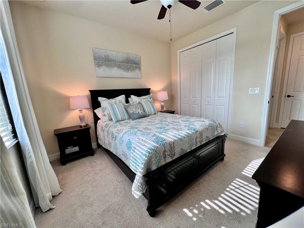 9419 Piacere Way Naples, FL 34113 - Photo 11 of 19 a bedroom with a bed and a walk in closet